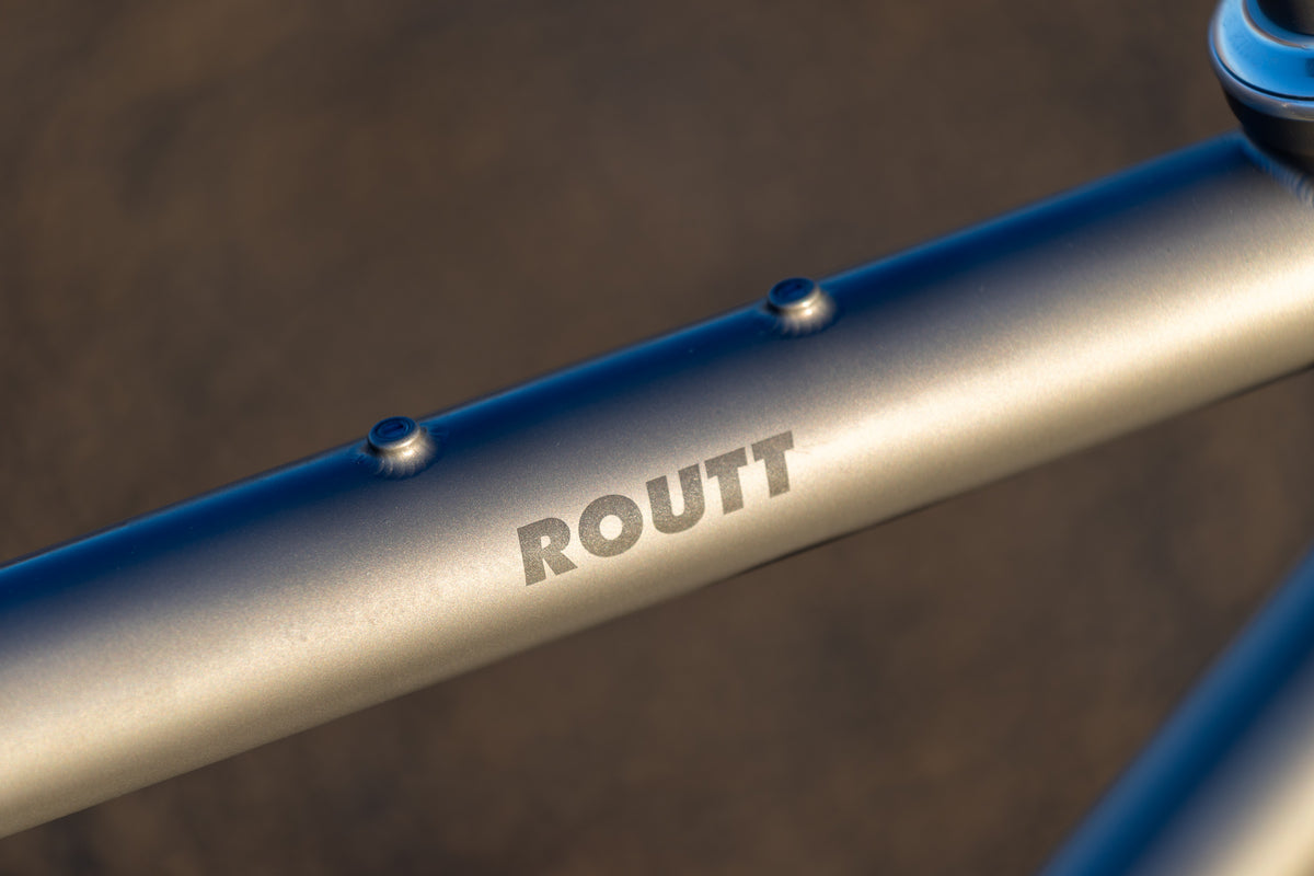 Brushed titanium top tube with Routt logo and bento bag mounts