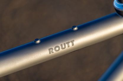 Brushed titanium top tube with Routt logo and bento bag mounts
